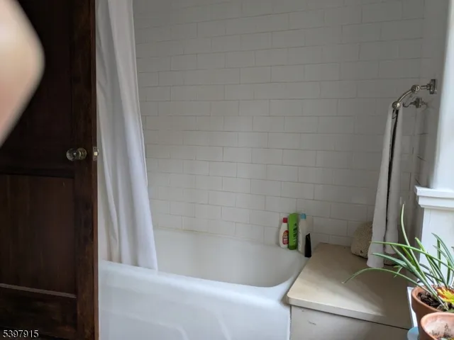a bath tub sitting in a bathroom next to a sink