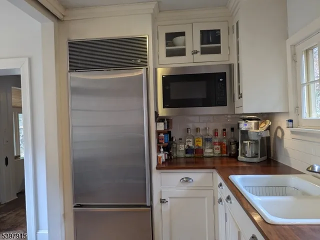 a kitchen with a refrigerator and a sink