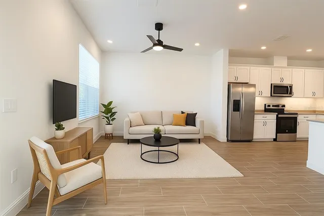 a living room with furniture and a flat screen tv