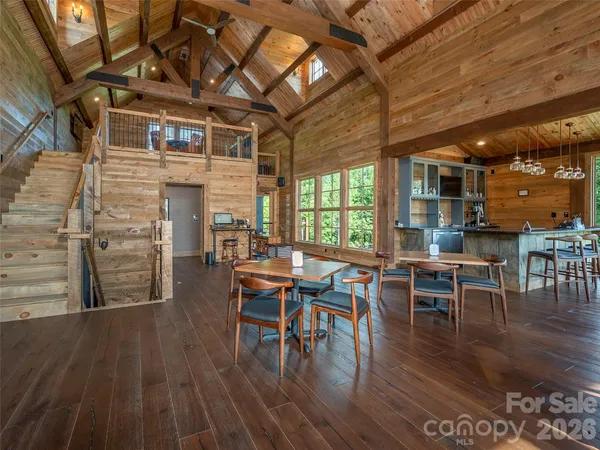 a dining room with wooden floor a table and chairs