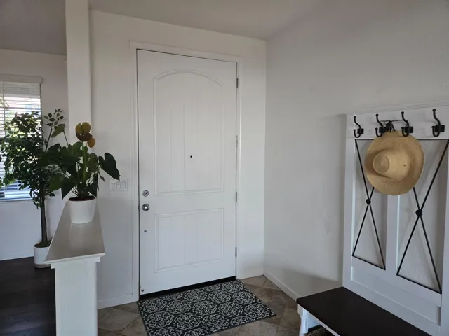 a living room with furniture a ceiling fan and a window