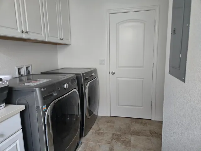 a kitchen with stainless steel appliances kitchen island granite countertop a refrigerator a stove a sink and a dining table with wooden floor