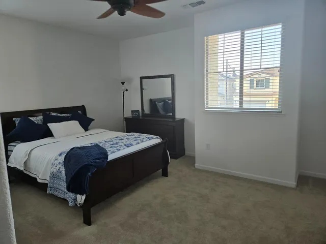 a kitchen with sink stove top oven dining table and chairs