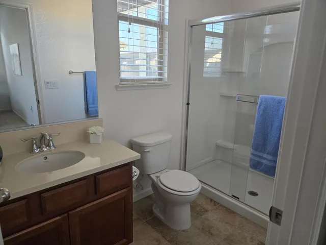 a kitchen with a dining table cabinets and refrigerator