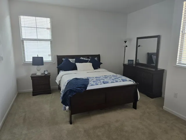 a kitchen with kitchen island granite countertop a sink a stove and a refrigerator
