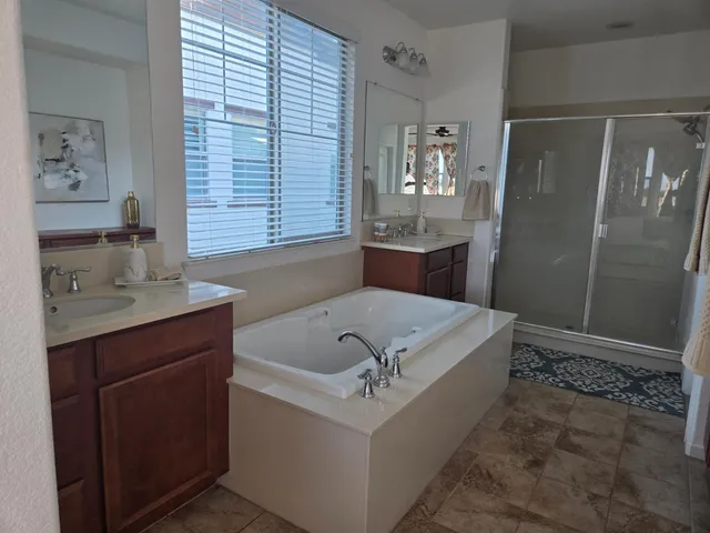 a kitchen with stainless steel appliances granite countertop a kitchen island a table and chairs