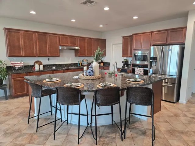 a living room with furniture kitchen view and a fireplace