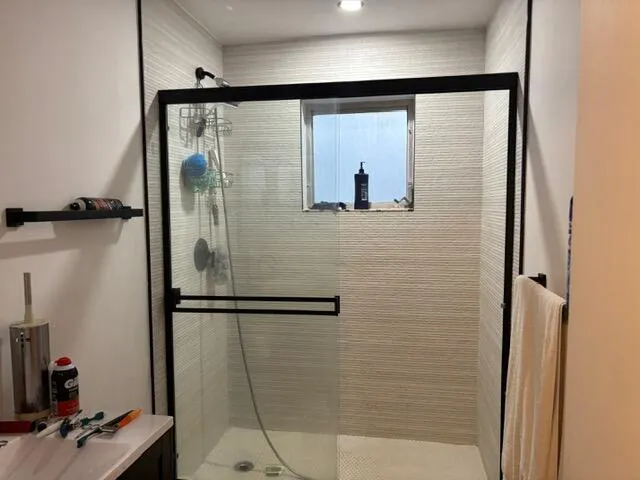 a bathroom with a glass shower door