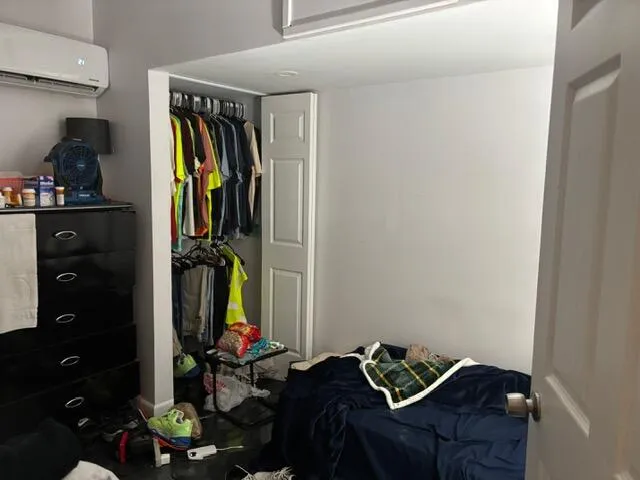 a bedroom with a bed and a mirror