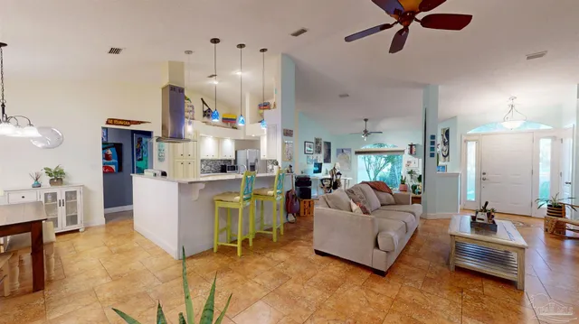 a living room with furniture a piano and a flat screen tv