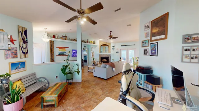 a view of a livingroom with furniture and a ceiling fan