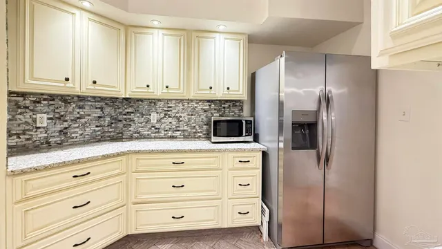 a bedroom with a bed dresser and a book shelf