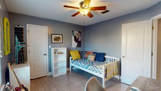 a dining room with furniture potted plants and wooden floor