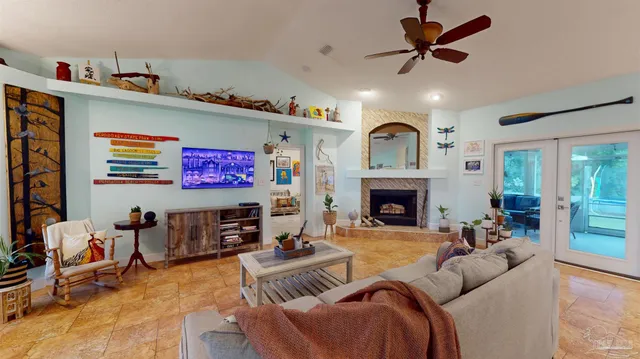 a living room with furniture a fireplace and a flat screen tv
