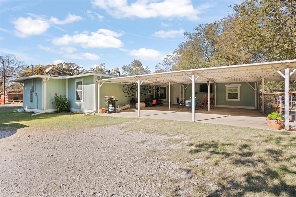 605 South 3rd Street Grandview, TX 76050 - Photo 16 of 23 Rear view of house with a yard, an attached carport, a pergola, and a patio area
