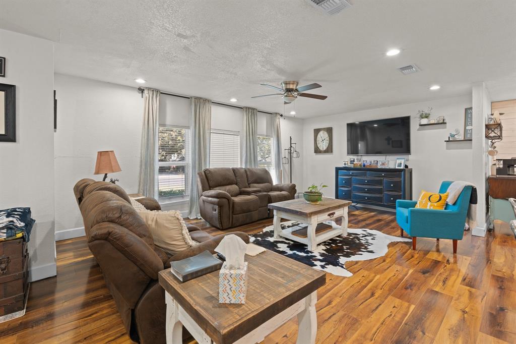 605 South 3rd Street Grandview, TX 76050 - Photo 4 of 23 Living room with dark wood-style floors, a textured ceiling, recessed lighting, and a ceiling fan