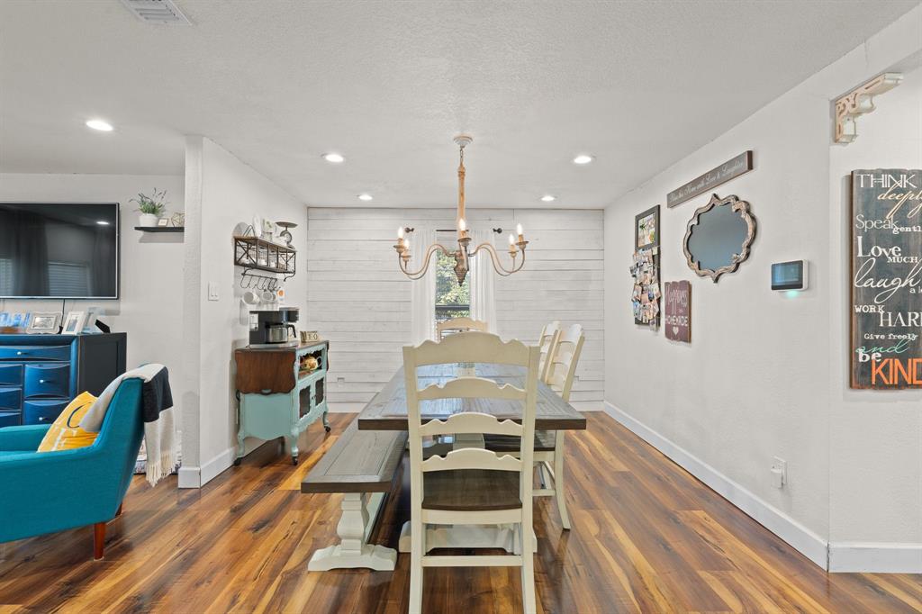 605 South 3rd Street Grandview, TX 76050 - Photo 8 of 23 Dining area with a chandelier, dark wood-type flooring, and a textured ceiling