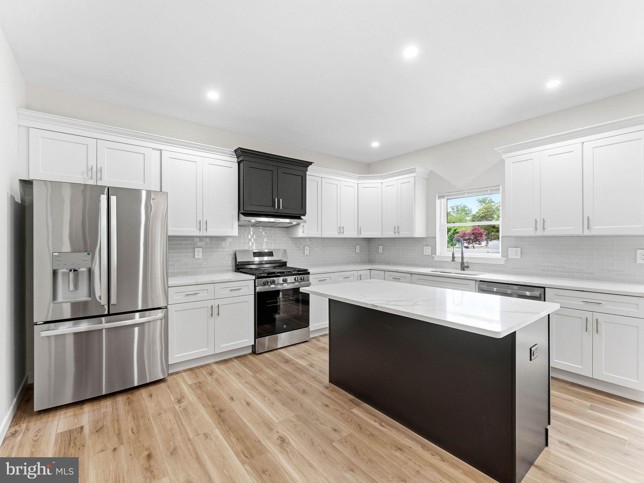 1327 Filbert Street Glassboro, NJ 08028 - Photo 21 of 47 Sleek modern kitchen with island charm.