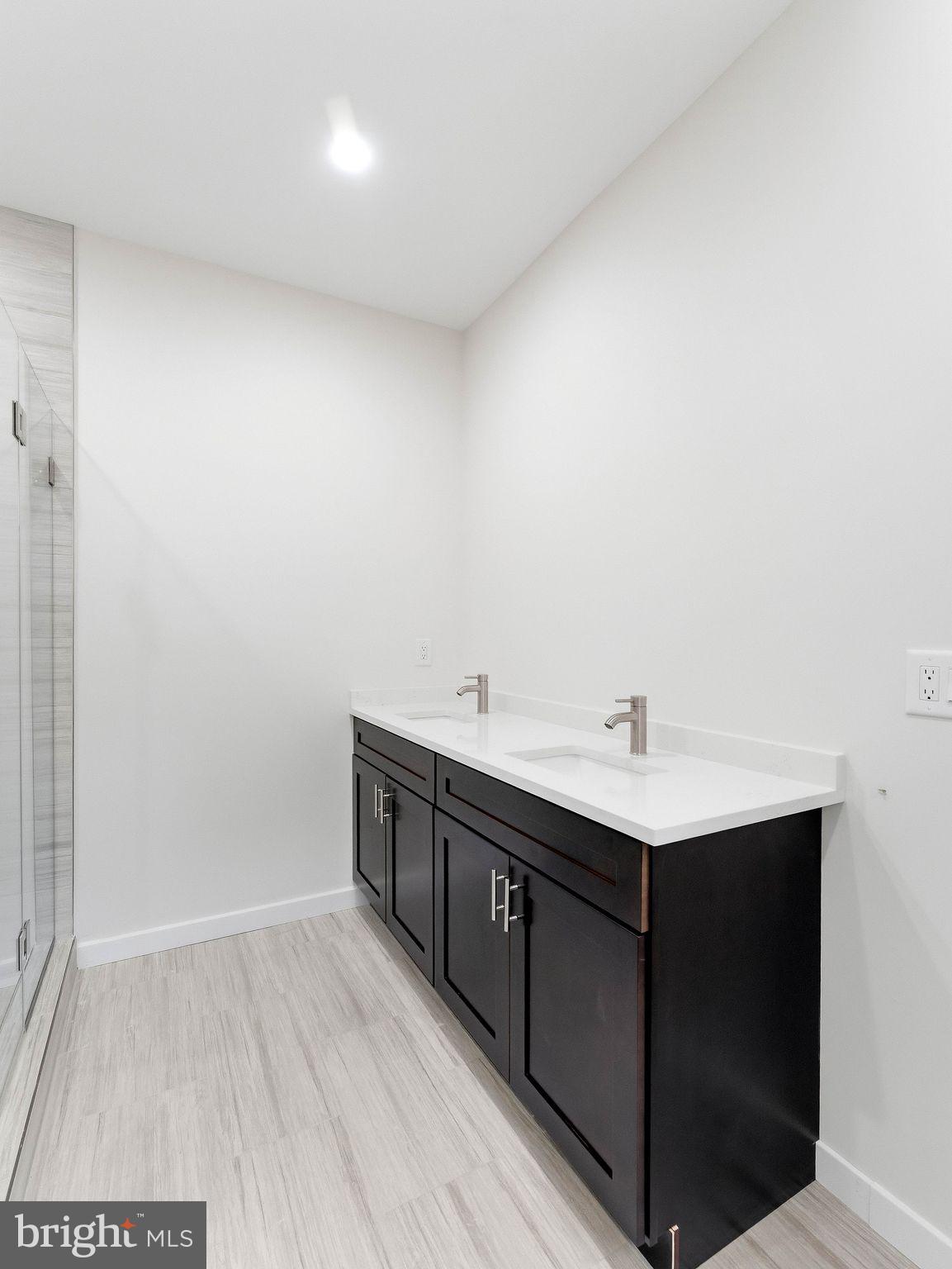 1327 Filbert Street Glassboro, NJ 08028 - Photo 30 of 47 Sleek modern bathroom with dual sinks.