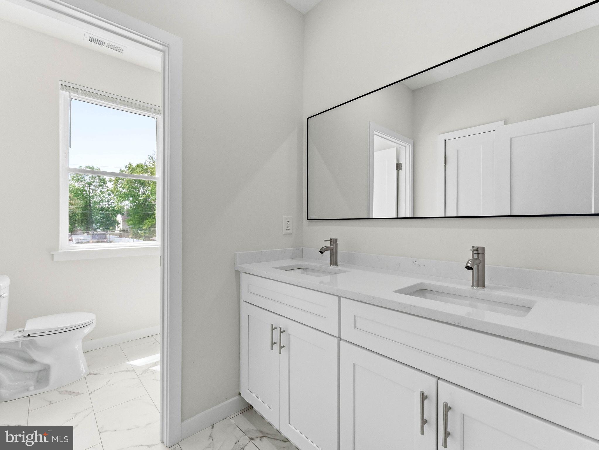 1327 Filbert Street Glassboro, NJ 08028 - Photo 38 of 47 Sleek modern bathroom with natural light.