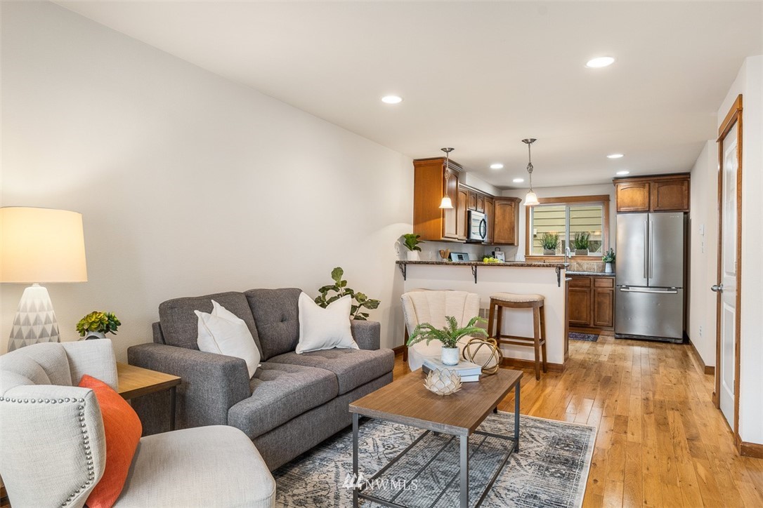 1122 North 92nd Street, Unit B Seattle, WA 98103 - Photo 15 of 32 a living room with furniture and kitchen view