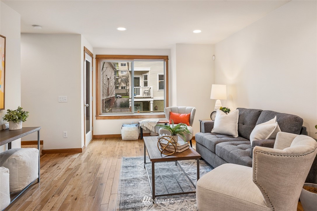 1122 North 92nd Street, Unit B Seattle, WA 98103 - Photo 17 of 32 a living room with furniture and wooden floor