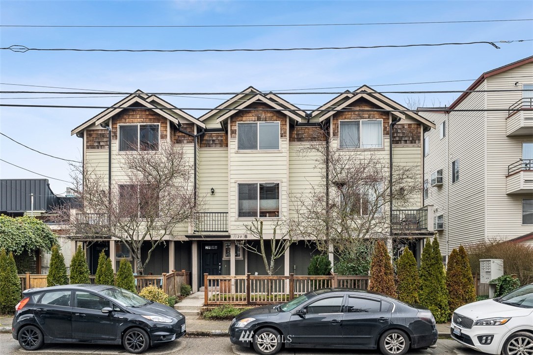 1122 North 92nd Street, Unit B Seattle, WA 98103 - Photo 2 of 32 a front view of a residential apartment building with a yard