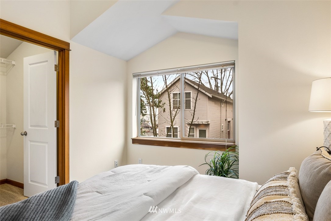 1122 North 92nd Street, Unit B Seattle, WA 98103 - Photo 26 of 32 a bedroom with a bed and a large window