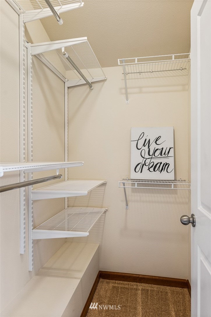 1122 North 92nd Street, Unit B Seattle, WA 98103 - Photo 27 of 32 a view of a room with racks on the wall