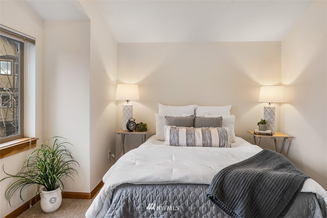 1122 North 92nd Street, Unit B Seattle, WA 98103 - Photo 28 of 32 a bedroom with a bed and potted plant
