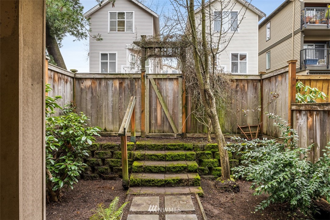 1122 North 92nd Street, Unit B Seattle, WA 98103 - Photo 29 of 32 front view of a house with a small yard