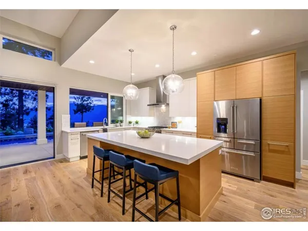 a living room with furniture dining table a large window and wooden floor