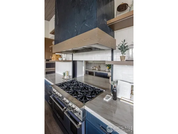 a living room with furniture kitchen view and a wooden floor