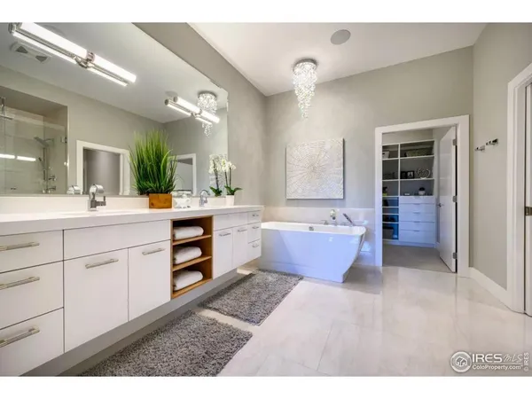 a kitchen with stainless steel appliances granite countertop a table chairs and a refrigerator
