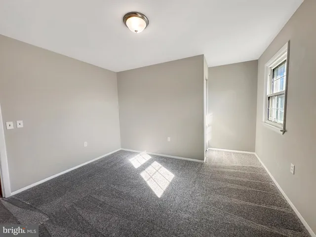 a front view of a lake with a patio table and chairs