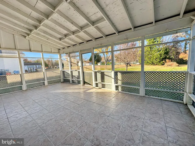 a front view of a multi story building with yard and retail shops