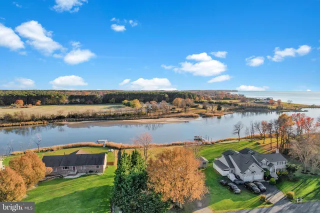 a view of an empty room with wooden floor and closet