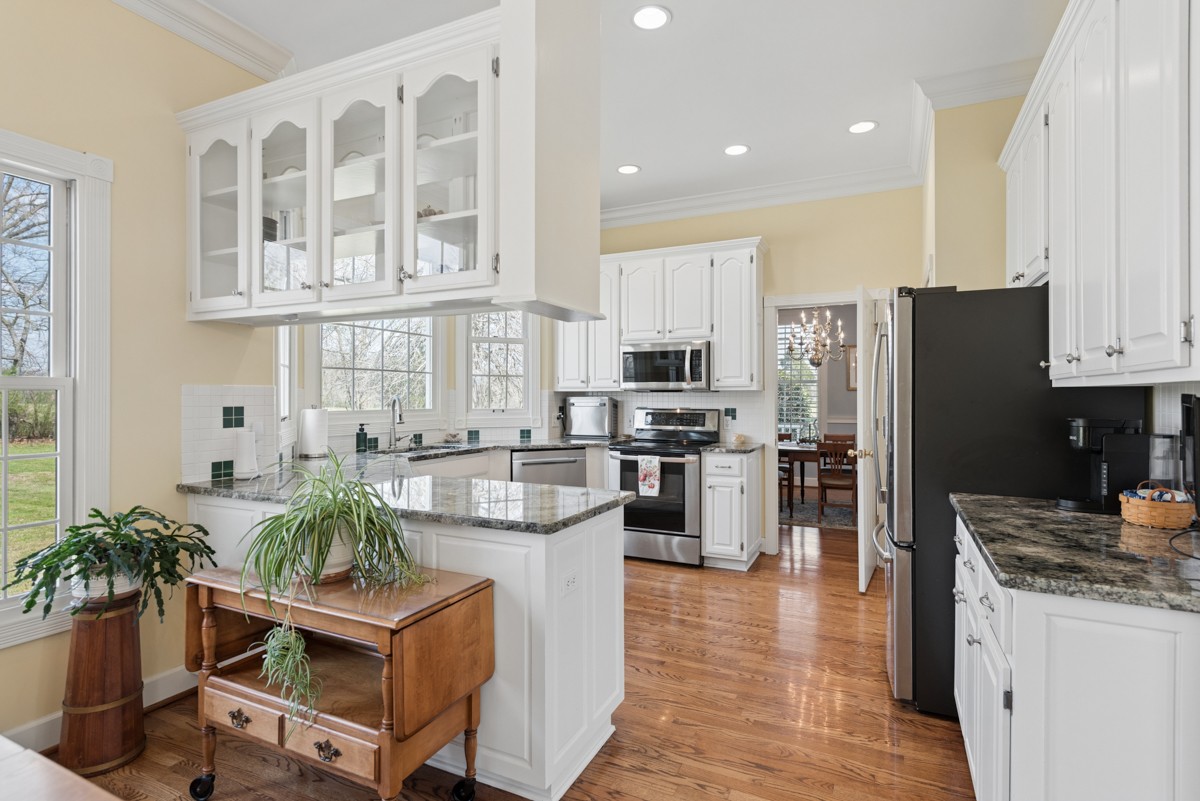 255 Lindsey Hollow Road Gallatin, TN 37066 - Photo 14 of 40 a kitchen with a refrigerator and a stove top oven
