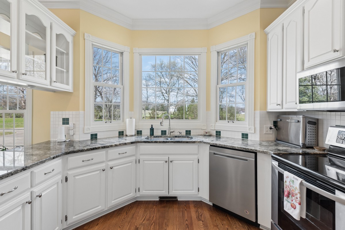 255 Lindsey Hollow Road Gallatin, TN 37066 - Photo 15 of 40 a kitchen with granite countertop white cabinets and white stainless steel appliances