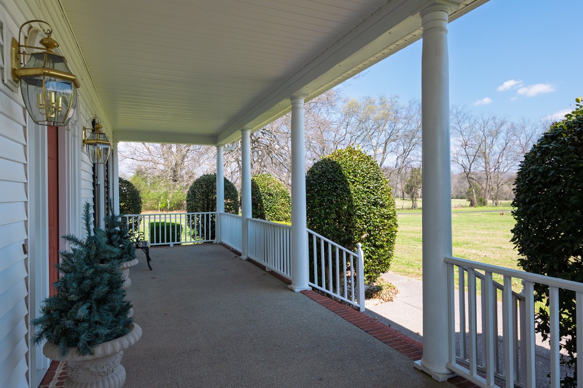 255 Lindsey Hollow Road Gallatin, TN 37066 - Photo 5 of 40 a view of a porch with chairs and floor to ceiling window