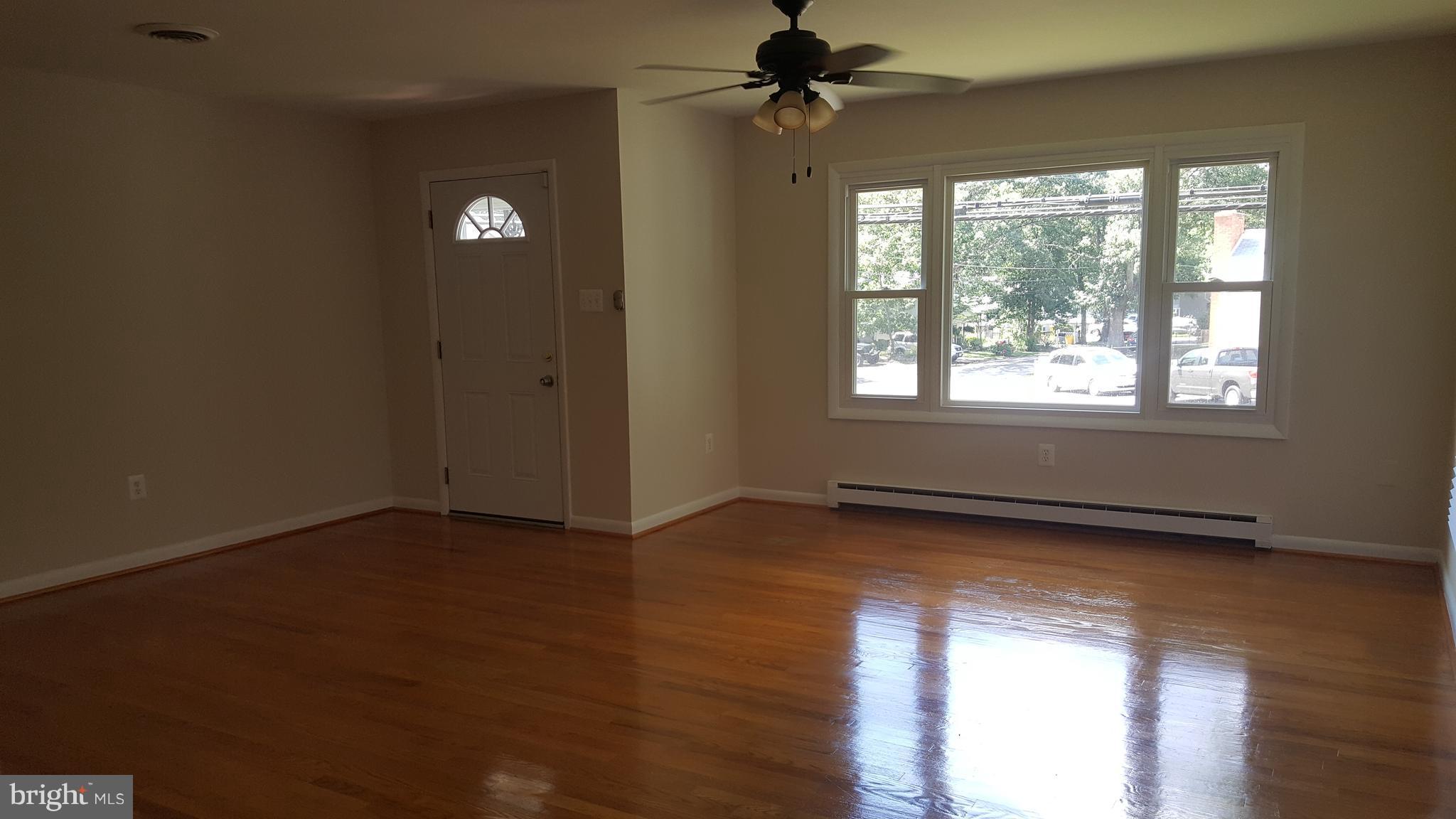 331 Londontown Road Edgewater, MD 21037 - Photo 4 of 23 a view of an empty room with wooden floor and a window