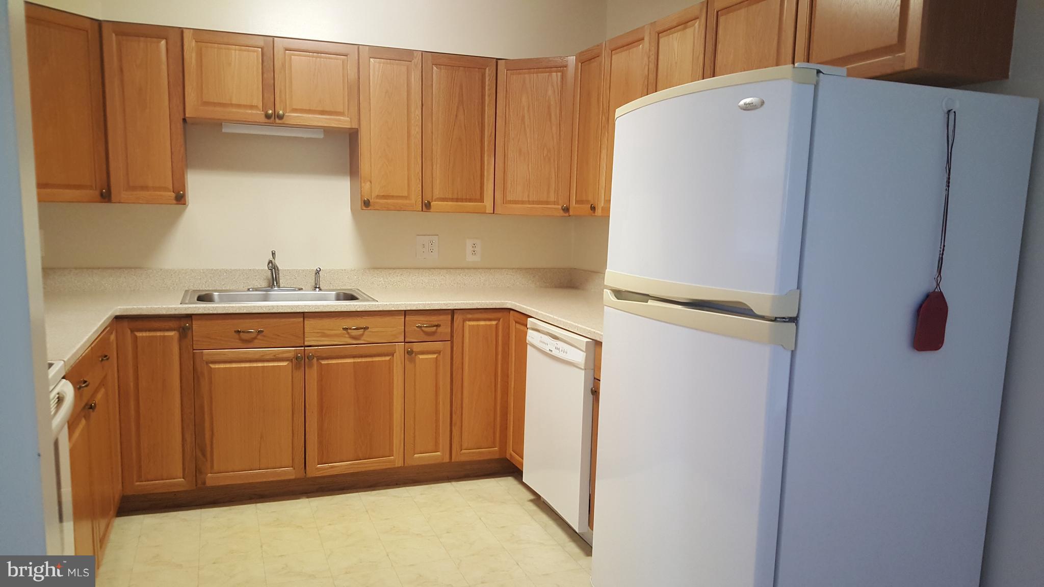331 Londontown Road Edgewater, MD 21037 - Photo 7 of 23 a kitchen with a refrigerator and cabinets