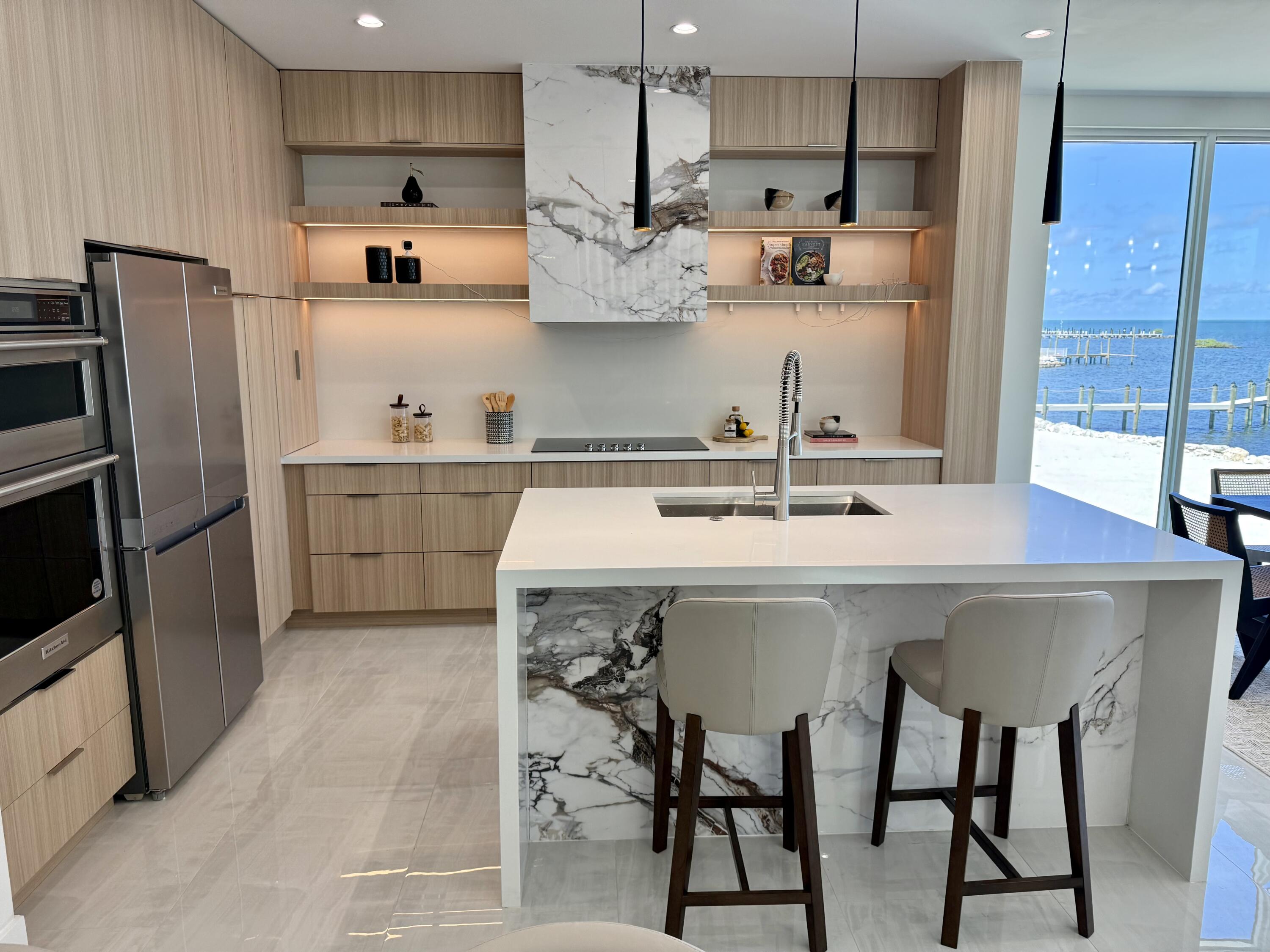 990 41st Street, Unit 10 Marathon, FL 33050 - Photo 14 of 55 a kitchen with stainless steel appliances a sink a stove a refrigerator and cabinets