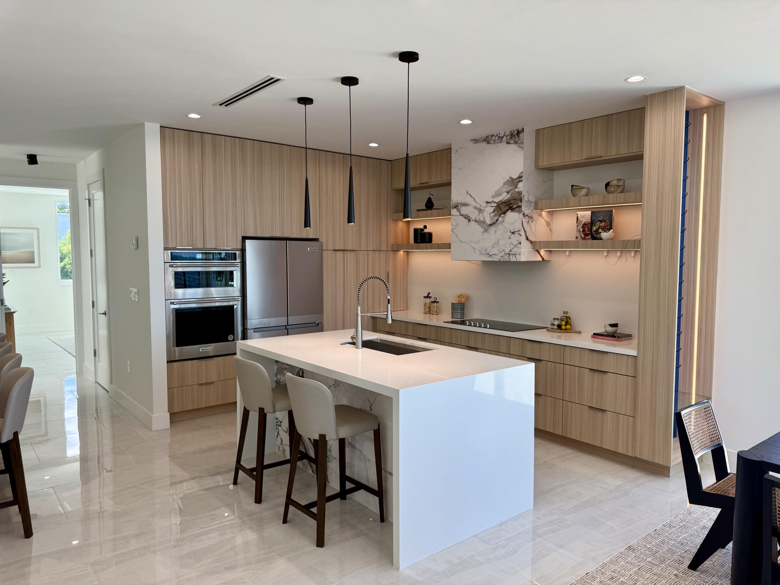990 41st Street, Unit 10 Marathon, FL 33050 - Photo 18 of 55 a kitchen with kitchen island a stove a table and chairs in it