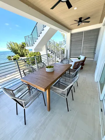 a living room with table chairs and a large window