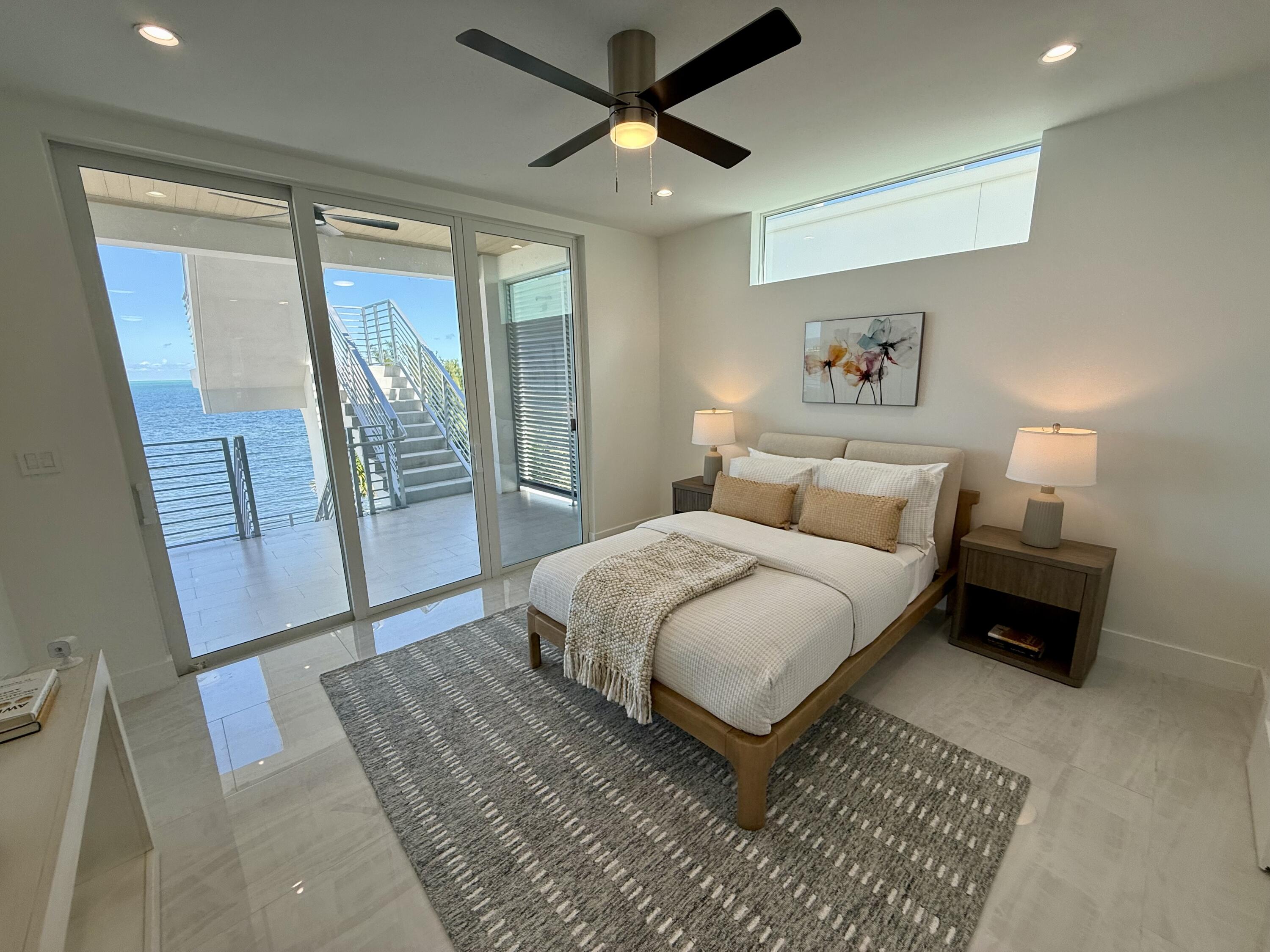 990 41st Street, Unit 10 Marathon, FL 33050 - Photo 34 of 55 a bedroom with a bed and a mirror