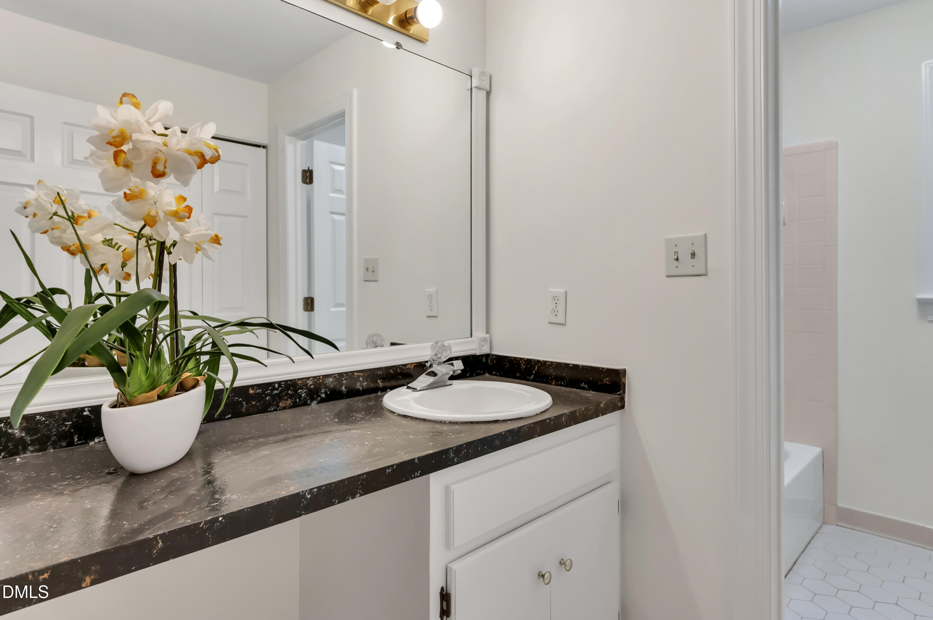 7500 Drayton Court Raleigh, NC 27615 - Photo 15 of 27 a bathroom with a granite countertop sink a toilet and a mirror