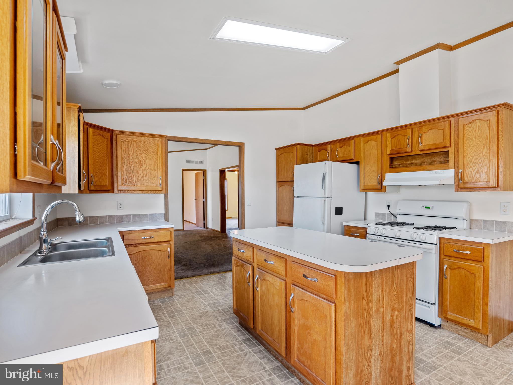 610 Audrey Drive, Unit 610 Dover, DE 19901 - Photo 13 of 27 a large kitchen with stainless steel appliances granite countertop a sink stove and refrigerator
