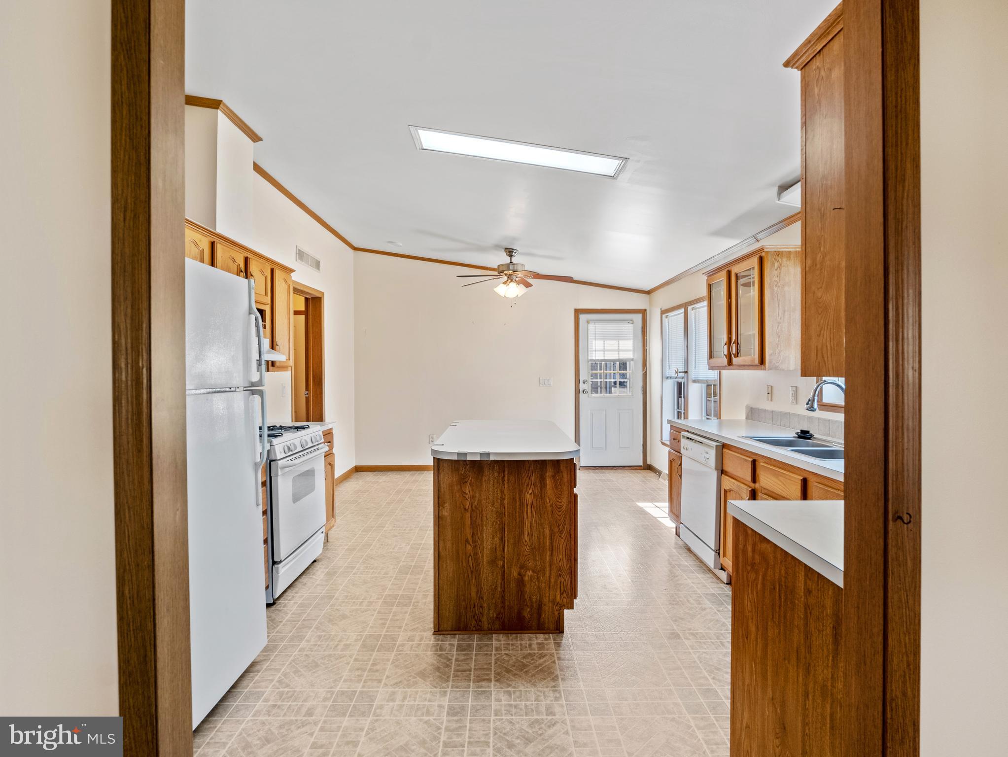 610 Audrey Drive, Unit 610 Dover, DE 19901 - Photo 9 of 27 a hallway with stainless steel appliances granite countertop a refrigerator and a sink
