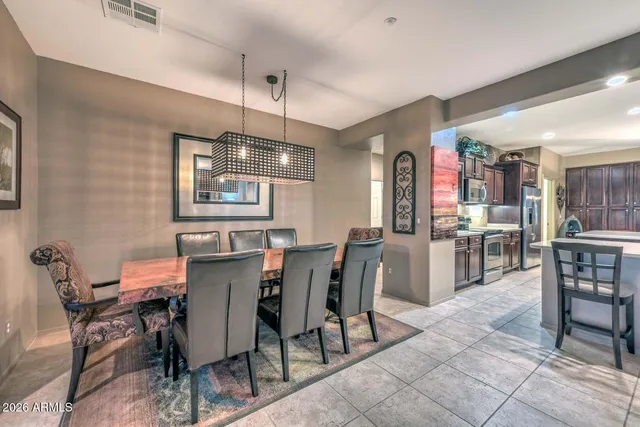a view of a dining room with furniture and chandelier
